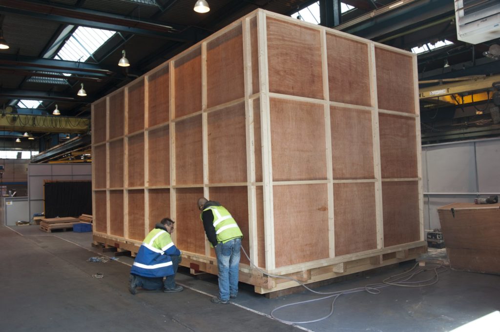 Custom wood case being prepared for shipping export goods