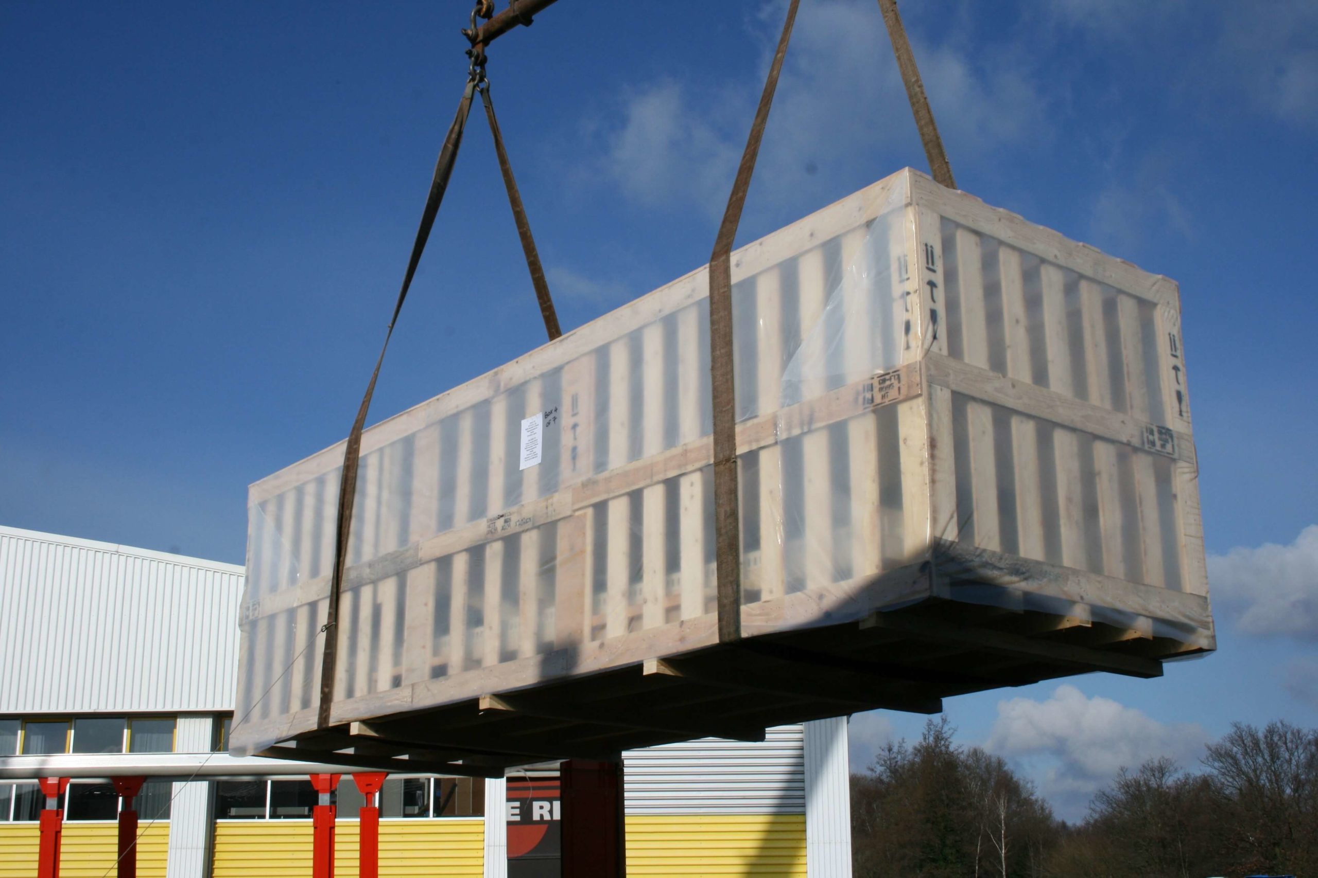 Large wooden case being loaded onto shipment